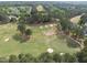 A lush green golf course with manicured fairways and sand traps surrounded by beautiful trees at 925 Hidden Jewel Ln, Wake Forest, NC 27587