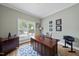 Bright office features a wood desk, large window, and classic trim for a functional workspace at 925 Hidden Jewel Ln, Wake Forest, NC 27587