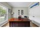 Cozy office space features a large wood desk, neutral paint, and bright natural light from a window at 925 Hidden Jewel Ln, Wake Forest, NC 27587