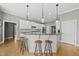 Bright and spacious kitchen featuring a central island, barstool seating, and modern appliances at 925 Hidden Jewel Ln, Wake Forest, NC 27587