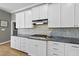 Bright kitchen featuring granite countertops, stainless steel appliances, and white cabinetry at 925 Hidden Jewel Ln, Wake Forest, NC 27587