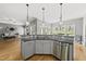 Open-concept kitchen with stainless steel appliances, granite countertops, and views of the living area at 925 Hidden Jewel Ln, Wake Forest, NC 27587