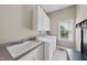 Well-organized laundry room with white cabinets and modern appliances at 925 Hidden Jewel Ln, Wake Forest, NC 27587