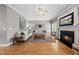 Living room with fireplace, hardwood floors, neutral paint, and bright natural light at 925 Hidden Jewel Ln, Wake Forest, NC 27587