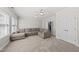 Spacious living room featuring a comfortable sectional sofa, carpet floors, and natural light at 925 Hidden Jewel Ln, Wake Forest, NC 27587