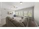Spacious living room featuring a comfortable sectional sofa, carpet floors, a TV, and natural light at 925 Hidden Jewel Ln, Wake Forest, NC 27587