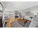 Bright open-concept living room flows into kitchen; features hardwood floors, ceiling fan and neutral decor at 925 Hidden Jewel Ln, Wake Forest, NC 27587