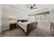 Elegant main bedroom featuring a king bed, bedside tables with lamps, and a large window at 925 Hidden Jewel Ln, Wake Forest, NC 27587
