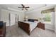 Comfortable main bedroom with a king bed, nightstands, and large windows offering a bright, airy feel at 925 Hidden Jewel Ln, Wake Forest, NC 27587