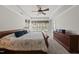 Spacious main bedroom with a king bed, a tray ceiling, and large windows providing ample natural light at 925 Hidden Jewel Ln, Wake Forest, NC 27587