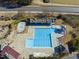 Aerial view of a community pool area featuring a large pool, pool, slide, and bath house at 925 Hidden Jewel Ln, Wake Forest, NC 27587