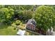 Aerial view of a brick home showing the roof, backyard, landscaping, and surrounding trees at 925 S Chestnut St, Henderson, NC 27536
