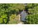 An aerial view displays the home's layout, surrounded by lush trees and a neatly kept yard at 925 S Chestnut St, Henderson, NC 27536