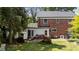 Backyard view featuring a patio, and lush greenery, ideal for outdoor enjoyment at 925 S Chestnut St, Henderson, NC 27536