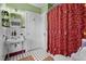 Cozy bathroom featuring patterned tiles and a large shower curtain at 925 S Chestnut St, Henderson, NC 27536