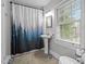 Bathroom featuring a pedestal sink, black-and-white tile and walk-in shower at 925 S Chestnut St, Henderson, NC 27536
