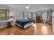 Bright primary bedroom featuring hardwood floors, large windows and a ceiling fan at 925 S Chestnut St, Henderson, NC 27536