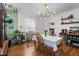 Bright dining room with hardwood floors, a dining table and chairs and large windows at 925 S Chestnut St, Henderson, NC 27536