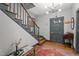 Bright foyer features a staircase, modern light fixture and hardwood floors and rug at 925 S Chestnut St, Henderson, NC 27536