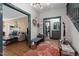 Open-concept foyer with wood floors leading to a living room and kitchen and a staircase at 925 S Chestnut St, Henderson, NC 27536