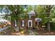 Charming brick home with a lush front yard, manicured landscaping, and inviting walkway at 925 S Chestnut St, Henderson, NC 27536