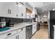 A modern kitchen features granite countertops, stainless steel appliances, and white cabinets at 925 S Chestnut St, Henderson, NC 27536