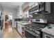 This cozy kitchen features stainless steel appliances, tile backsplash, and gas range cooktop at 925 S Chestnut St, Henderson, NC 27536