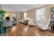 Bright living room featuring hardwood floors, with a staircase and comfortable seating at 925 S Chestnut St, Henderson, NC 27536