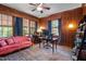 Traditional office space with wood paneled walls, windows and ceiling fan and decorative rug at 925 S Chestnut St, Henderson, NC 27536