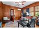 Cozy home office with wood paneled walls, a desk, and hardwood flooring at 925 S Chestnut St, Henderson, NC 27536