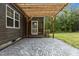 Back yard with a brick patio featuring a pergola with string lights for outdoor entertainment at 96 Linda Lou Ln, Angier, NC 27501