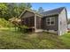 Back of house featuring a screened porch, brick patio with pergola and a sloping back yard at 96 Linda Lou Ln, Angier, NC 27501