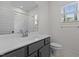 Modern bathroom with gray vanity, white countertop, and combined tub and shower at 96 Linda Lou Ln, Angier, NC 27501