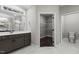 Bathroom showing vanity, toilet, and walk-in closet with shelving at 96 Linda Lou Ln, Angier, NC 27501