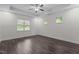 Bright bedroom with multiple windows, tray ceiling, and hardwood flooring at 96 Linda Lou Ln, Angier, NC 27501