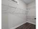 Walk-in closet with custom shelving and hardwood floors at 96 Linda Lou Ln, Angier, NC 27501