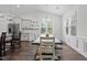 Bright dining room with ample natural light, featuring a modern chandelier and views of the backyard at 96 Linda Lou Ln, Angier, NC 27501