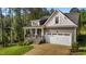 Charming home featuring stone accents, a covered front porch, and an attached two-car garage at 96 Linda Lou Ln, Angier, NC 27501