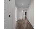 Bright hallway with wood flooring, white trim, and views of the living area beyond at 96 Linda Lou Ln, Angier, NC 27501