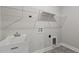 Bright laundry room includes utility sink and shelving, and hookups for a washer and dryer at 96 Linda Lou Ln, Angier, NC 27501