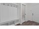Mudroom with storage bench and coat hooks next to the entrance and a door to a half bath at 96 Linda Lou Ln, Angier, NC 27501