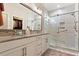 Luxurious bathroom with a glass-enclosed shower, double vanity, and walk-in closet at 1008 Sounding Ln, Durham, NC 27703