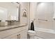 Clean bathroom with modern fixtures, tiled shower and tub, and ample counter space at 1008 Sounding Ln, Durham, NC 27703