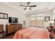 Spacious bedroom with a ceiling fan, large windows, and stylish decor at 1008 Sounding Ln, Durham, NC 27703