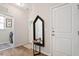 Welcoming entryway with hardwood floors, decorative mirror, and access to the laundry room at 1008 Sounding Ln, Durham, NC 27703