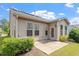 Charming home exterior featuring a delightful back patio with multiple windows and a door at 1008 Sounding Ln, Durham, NC 27703
