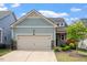 Charming home featuring a two-car garage, stone accents, and delightful landscaping at 1008 Sounding Ln, Durham, NC 27703