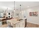 Open-concept living space with a kitchen island, stainless steel appliances, and hardwood floors at 1008 Sounding Ln, Durham, NC 27703