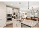 Modern kitchen with stainless steel appliances, granite countertops, and an open floor plan at 1008 Sounding Ln, Durham, NC 27703