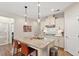 Bright kitchen featuring granite counters, pendant lights, a kitchen island, and a gas stovetop at 1008 Sounding Ln, Durham, NC 27703